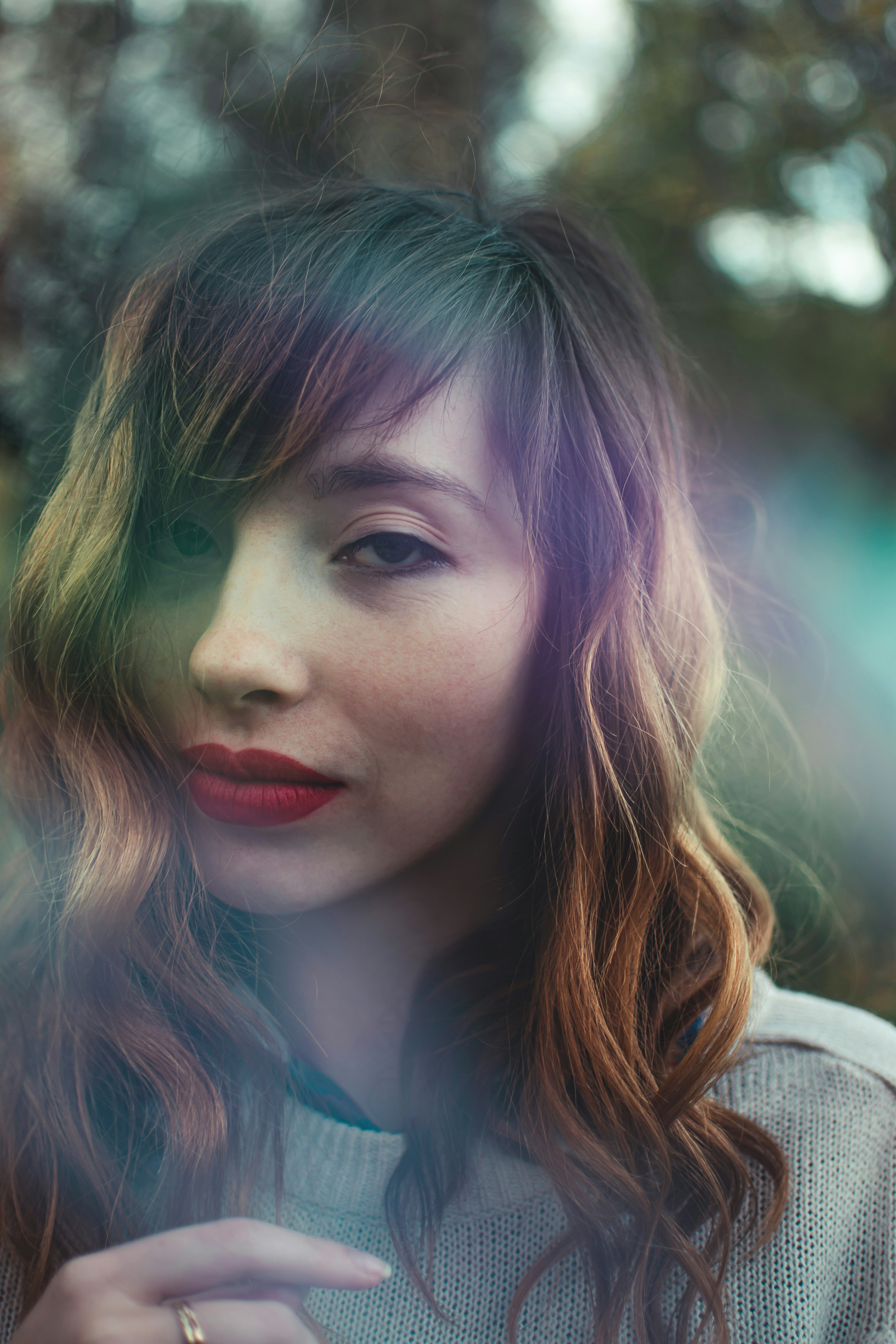 woman in gray shirt with red lipstick